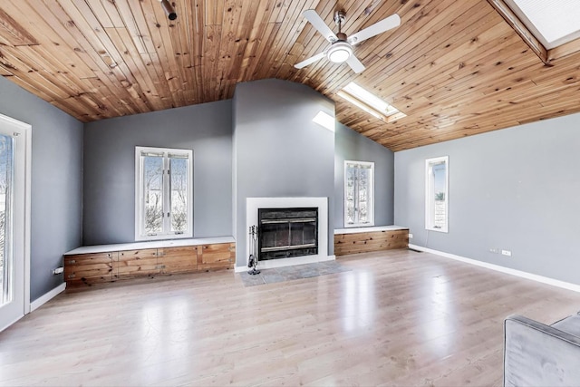 6S009 Steeple Run Dr, Naperville, IL 60540 - unfurnished living room with vaulted ceiling, ceiling fan, a skylight, a glass covered fireplace, and wood finished floors