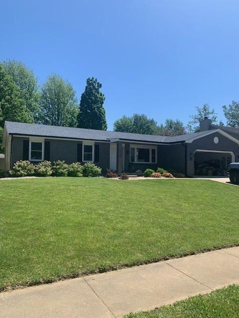 43 Kenfield Cir, Bloomington, IL 61704 - ranch-style house with an attached garage, a front lawn, a chimney, and brick siding