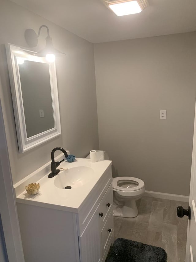 43 Kenfield Cir, Bloomington, IL 61704 - half bathroom featuring vanity, toilet, baseboards, and marble look tile flooring