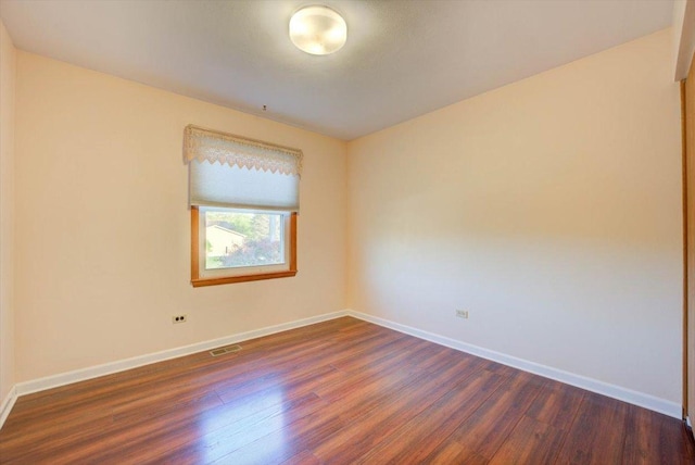38059 N Holdridge Ave, Beach Park, IL 60087 - spare room featuring dark wood-style floors and baseboards