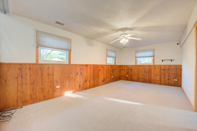 38059 N Holdridge Ave, Beach Park, IL 60087 - unfurnished room with wainscoting, wood walls, carpet floors, and a ceiling fan