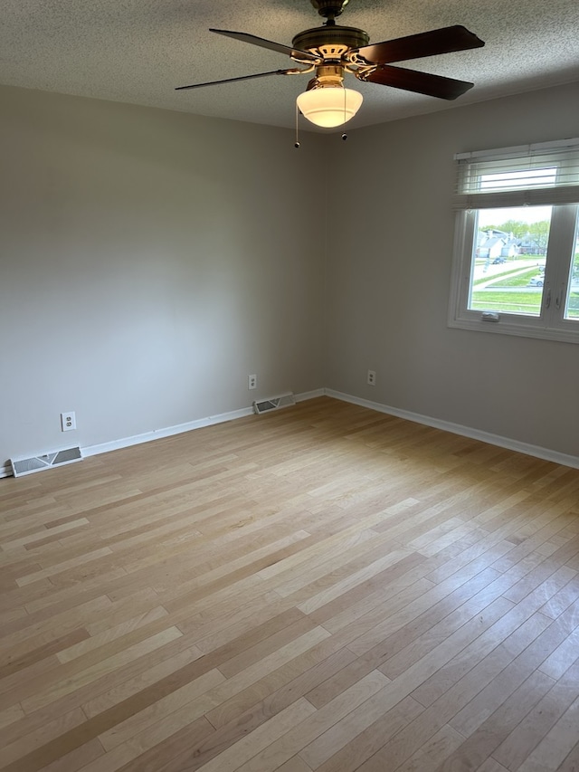 1326 Post Oak Ct Unit 1, Crest Hill, IL 60403 - unfurnished room featuring light wood finished floors, a textured ceiling, ceiling fan, and baseboards
