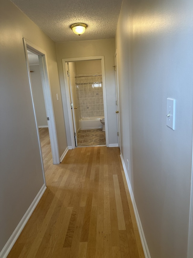 1326 Post Oak Ct Unit 1, Crest Hill, IL 60403 - hall with light wood-style flooring, a textured ceiling, and baseboards