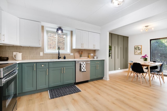 7925 Paxton Ave Unit 1A, Tinley Park, IL 60477 - kitchen featuring dishwasher, green cabinets, electric stove, a sink, and light wood-style flooring
