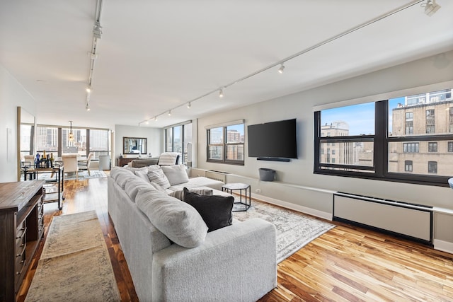 1313 N Ritchie Ct Unit 2001, Chicago, IL 60610 - living area with rail lighting, wood finished floors, and radiator