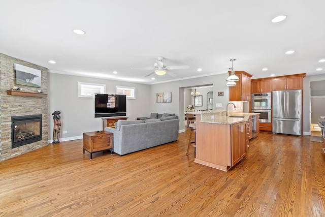 7317 W Greenleaf St, Chicago, IL 60631 - kitchen featuring appliances with stainless steel finishes, open floor plan, a breakfast bar area, a sink, and a ceiling fan