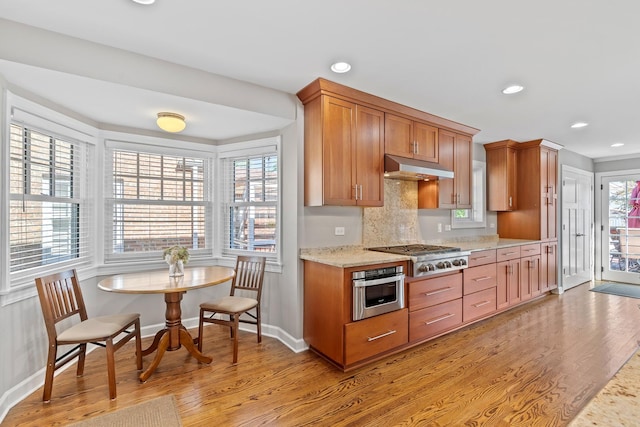 7317 W Greenleaf St, Chicago, IL 60631 - kitchen featuring stainless steel appliances, light wood finished floors, under cabinet range hood, baseboards, and recessed lighting