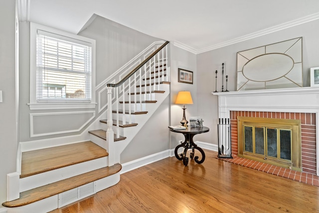 7317 W Greenleaf St, Chicago, IL 60631 - stairway featuring wood finished floors, ornamental molding, baseboards, and a fireplace
