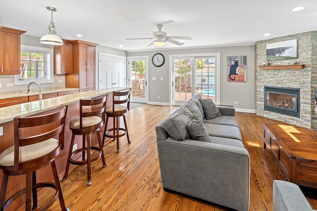 7317 W Greenleaf St, Chicago, IL 60631 - living area featuring a ceiling fan, light wood-type flooring, baseboards, a fireplace, and recessed lighting