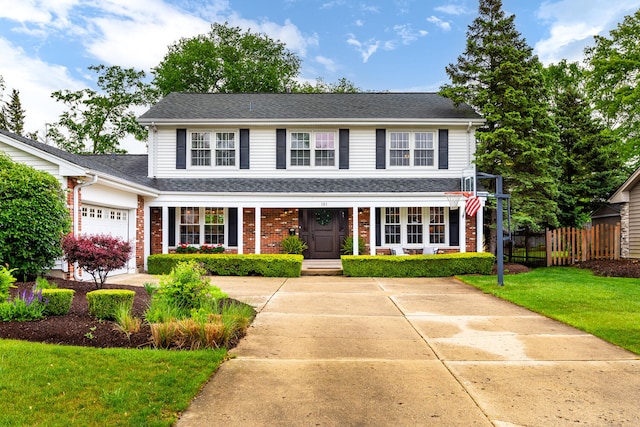 2S151 Stratford Rd, Glen Ellyn, IL 60137 - traditional home with an attached garage, brick siding, a porch, and roof with shingles