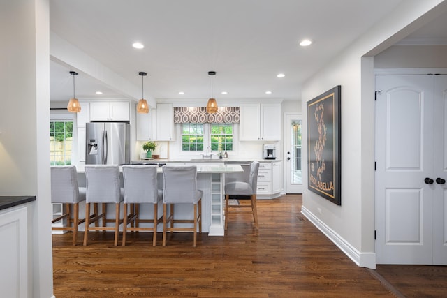 2S151 Stratford Rd, Glen Ellyn, IL 60137 - kitchen with stainless steel fridge with ice dispenser, a sink, white cabinets, a kitchen bar, and dark wood finished floors