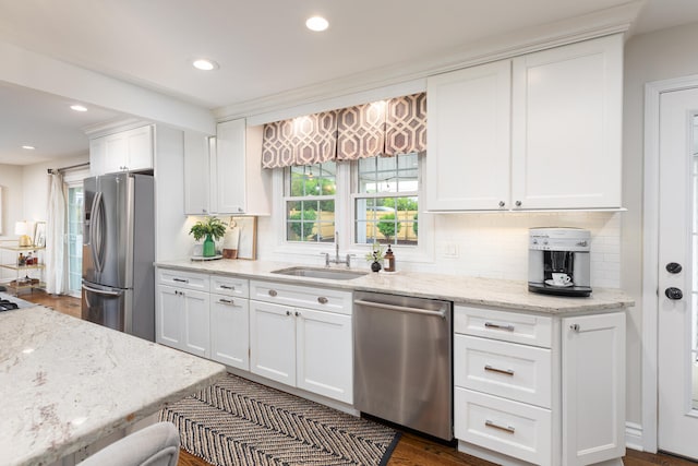 2S151 Stratford Rd, Glen Ellyn, IL 60137 - kitchen featuring appliances with stainless steel finishes, a sink, backsplash, white cabinetry, and light stone counters