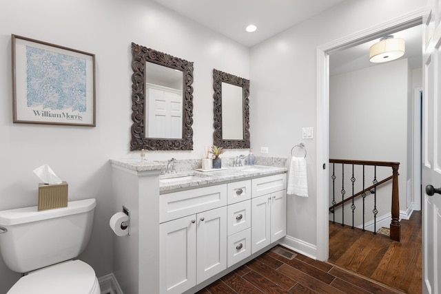 2S151 Stratford Rd, Glen Ellyn, IL 60137 - full bath with double vanity, wood finished floors, toilet, baseboards, and recessed lighting