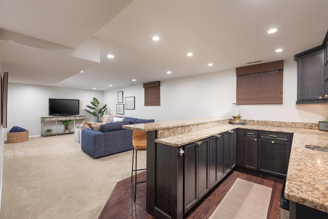 2S151 Stratford Rd, Glen Ellyn, IL 60137 - kitchen featuring a peninsula, recessed lighting, light stone counters, a kitchen breakfast bar, and open floor plan