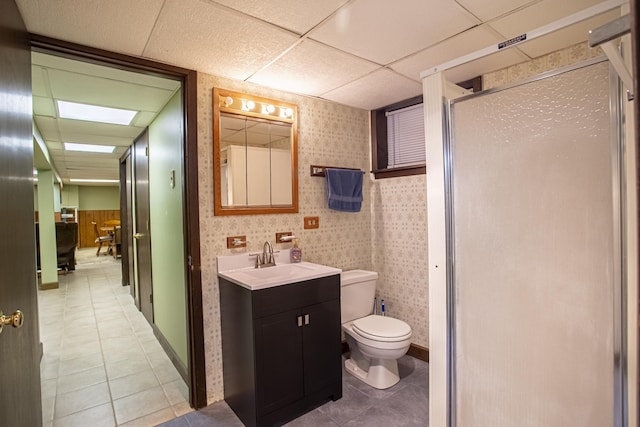 5148 S Newland Ave, Chicago, IL 60638 - bathroom featuring tile patterned floors, a paneled ceiling, vanity, a shower stall, and toilet
