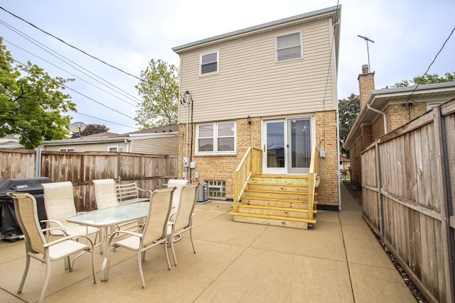 5148 S Newland Ave, Chicago, IL 60638 - back of property with entry steps, a patio area, a fenced backyard, and outdoor dining area
