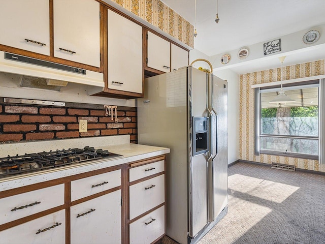 530 Fitch Rd, Rockford, IL 61109 - kitchen with refrigerator with ice dispenser, under cabinet range hood, wallpapered walls, stainless steel gas stovetop, and carpet flooring
