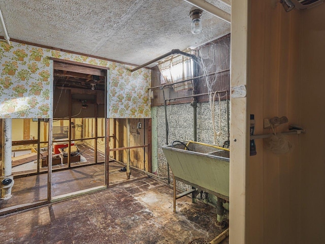 530 Fitch Rd, Rockford, IL 61109 - miscellaneous room featuring wallpapered walls, a textured ceiling, and a sink