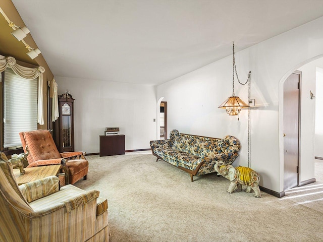 530 Fitch Rd, Rockford, IL 61109 - living area featuring arched walkways, carpet flooring, and baseboards