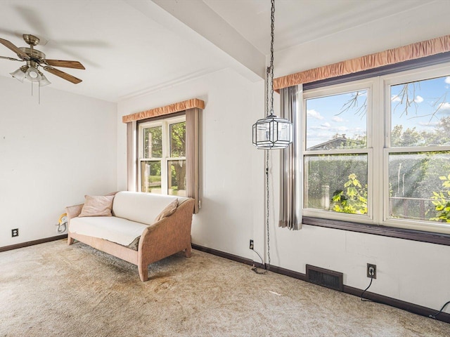 530 Fitch Rd, Rockford, IL 61109 - living area featuring carpet, baseboards, and a ceiling fan