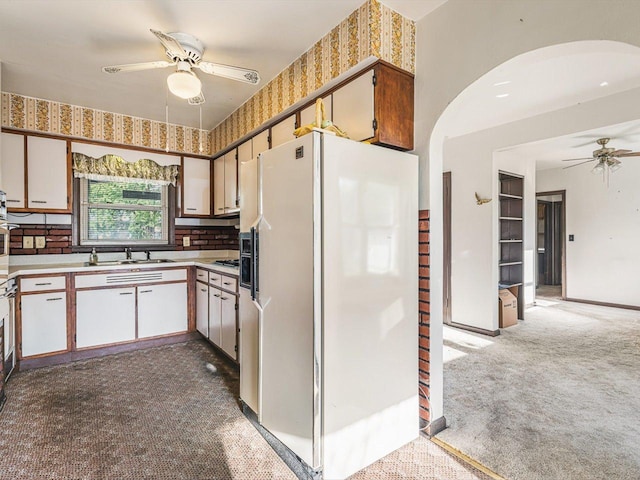530 Fitch Rd, Rockford, IL 61109 - kitchen with white refrigerator with ice dispenser, a ceiling fan, carpet, arched walkways, and light countertops