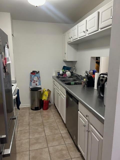 525 E Jefferson St Unit 1A, Bensenville, IL 60106 - kitchen with appliances with stainless steel finishes, a sink, light tile patterned floors, and white cabinetry