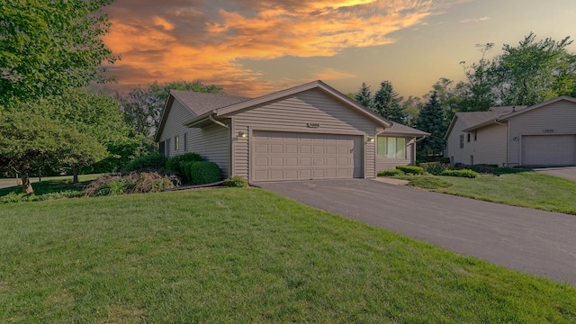 5008 Thistle Trl, Loves Park, IL 61111 - view of front of house featuring an attached garage, asphalt driveway, and a lawn