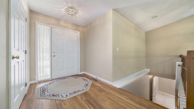 5008 Thistle Trl, Loves Park, IL 61111 - entrance foyer with wood finished floors, baseboards, and a textured ceiling