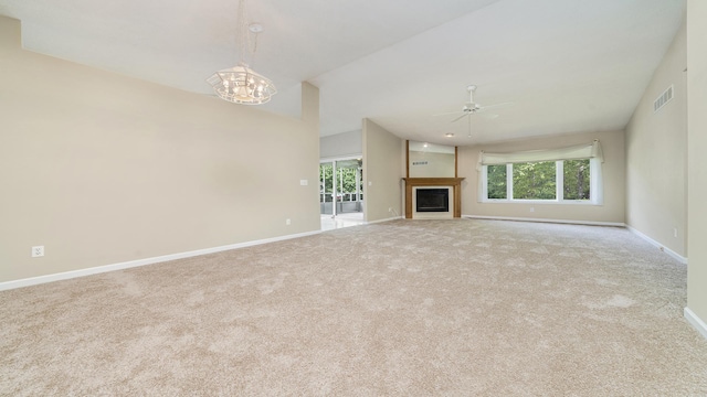 5008 Thistle Trl, Loves Park, IL 61111 - unfurnished living room with ceiling fan, carpet flooring, a chandelier, baseboards, and plenty of natural light