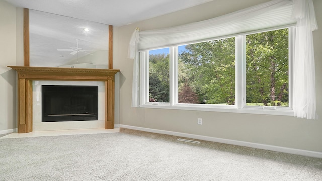 5008 Thistle Trl, Loves Park, IL 61111 - unfurnished living room featuring a ceiling fan, carpet, a fireplace with flush hearth, and healthy amount of natural light