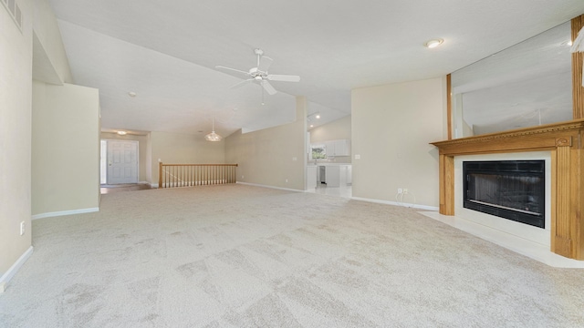 5008 Thistle Trl, Loves Park, IL 61111 - unfurnished living room featuring lofted ceiling, carpet, a fireplace with flush hearth, a ceiling fan, and baseboards