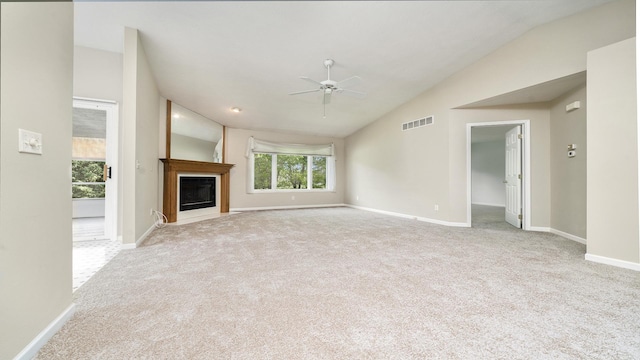 5008 Thistle Trl, Loves Park, IL 61111 - unfurnished living room featuring lofted ceiling, ceiling fan, carpet floors, a glass covered fireplace, and baseboards