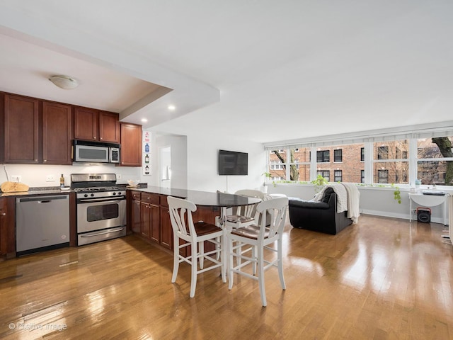 2300 N Commonwealth Ave Unit 2L, Chicago, IL 60614 - kitchen with stainless steel appliances, a peninsula, light wood-type flooring, healthy amount of natural light, and recessed lighting