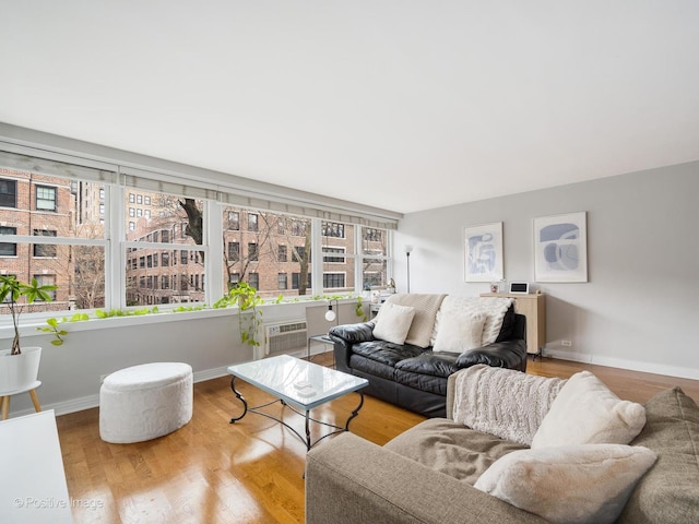 2300 N Commonwealth Ave Unit 2L, Chicago, IL 60614 - living room featuring wood finished floors, baseboards, and a wall unit AC