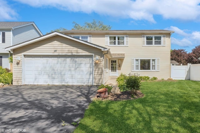 traditional-style house with an attached garage and driveway