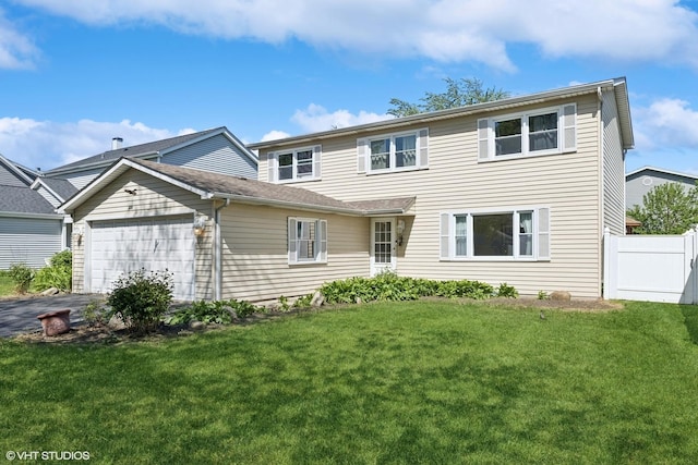 traditional-style home with a garage and asphalt driveway