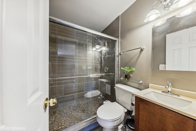 full bathroom with a shower stall, toilet, and vanity