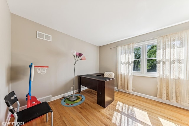 home office featuring wood finished floors and baseboards