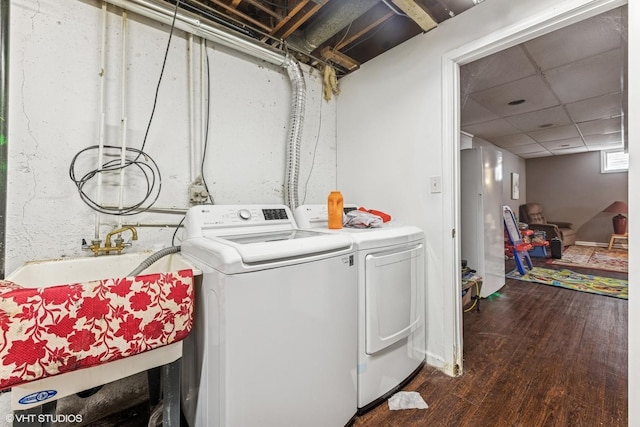 washroom with washing machine and dryer and dark wood-style flooring