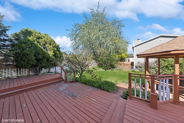 wooden terrace with a yard