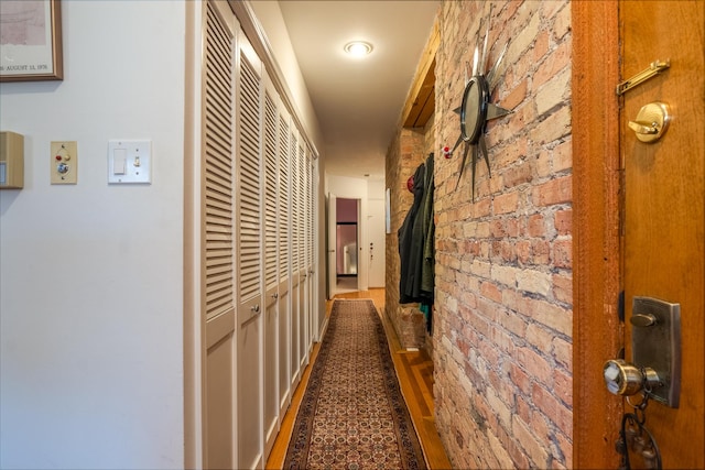 3711 N Pine Grove Ave Unit 2Nw, Chicago, IL 60613 - corridor featuring brick wall and wood finished floors