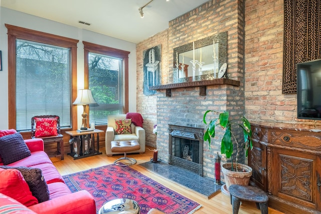 3711 N Pine Grove Ave Unit 2Nw, Chicago, IL 60613 - living area featuring wood finished floors, a brick fireplace, and track lighting
