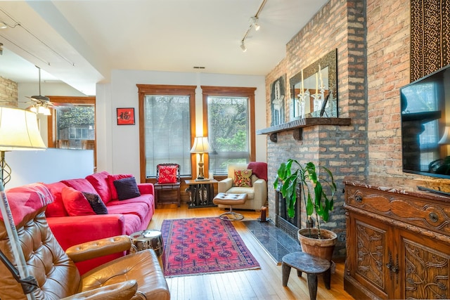 3711 N Pine Grove Ave Unit 2Nw, Chicago, IL 60613 - living room with wood-type flooring, healthy amount of natural light, a fireplace, and rail lighting