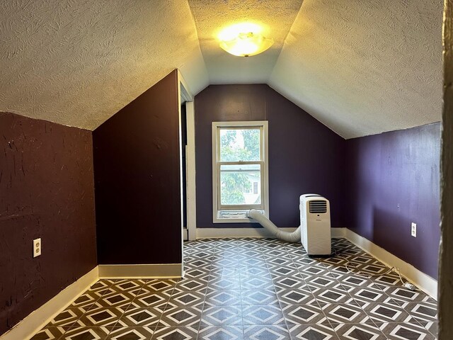 509 E Webster St, Clinton, IL 61727 - bonus room featuring a textured ceiling, tile patterned floors, and vaulted ceiling