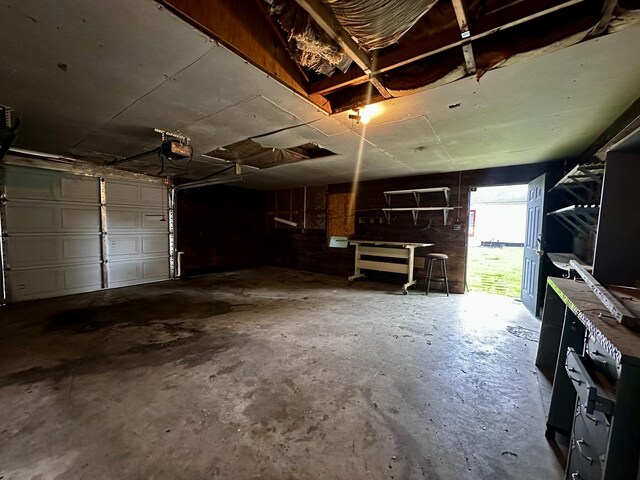 509 E Webster St, Clinton, IL 61727 - garage with a garage door opener and a workshop area
