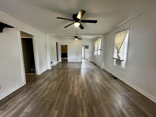 509 E Webster St, Clinton, IL 61727 - unfurnished living room featuring dark wood-style floors and baseboards