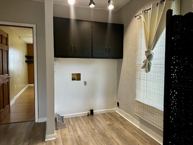 509 E Webster St, Clinton, IL 61727 - laundry area with cabinet space, washer hookup, light wood-style floors, and baseboards