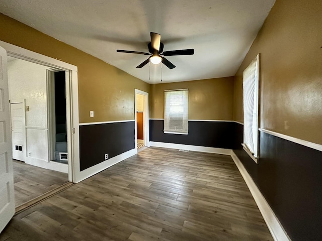 509 E Webster St, Clinton, IL 61727 - empty room with ceiling fan, wood finished floors, and baseboards