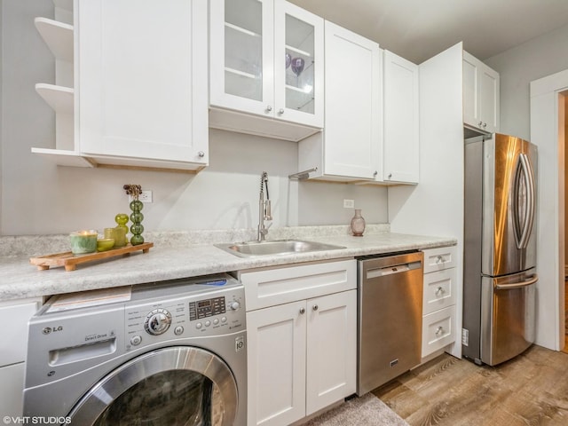 2250 N Dayton St Unit 3, Chicago, IL 60614 - kitchen with washer / dryer, appliances with stainless steel finishes, a sink, light wood-type flooring, and white cabinets