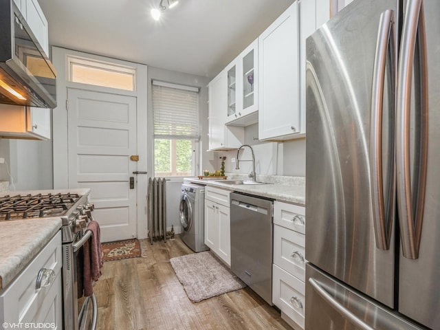 2250 N Dayton St Unit 3, Chicago, IL 60614 - kitchen with appliances with stainless steel finishes, a sink, washer / clothes dryer, wood finished floors, and white cabinetry